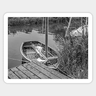 Small wooden boat moored to a quay heading on the Norfolk Broads Sticker